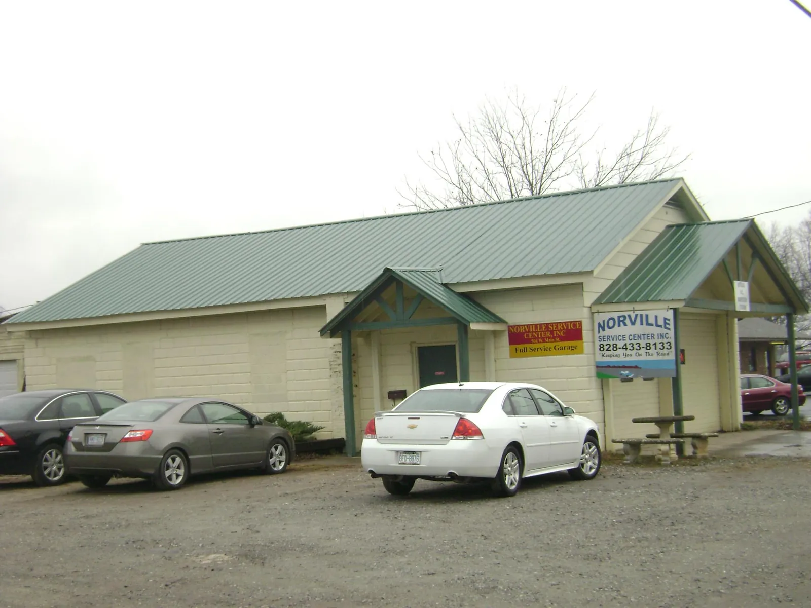 Green metal roof on a service garage with a covered entry in Antioch