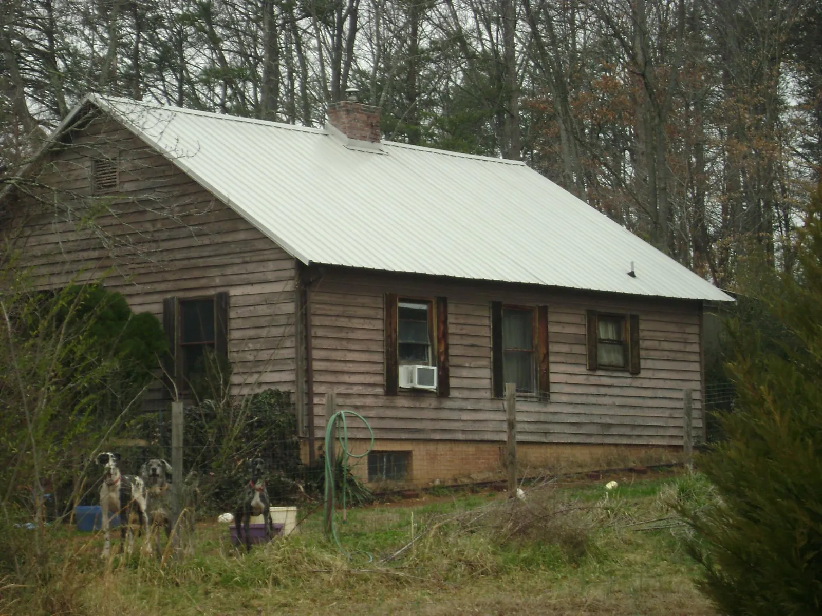 White metal roof on an old wood sided farmhouse, from a Metal Roof Installation job in Antioch